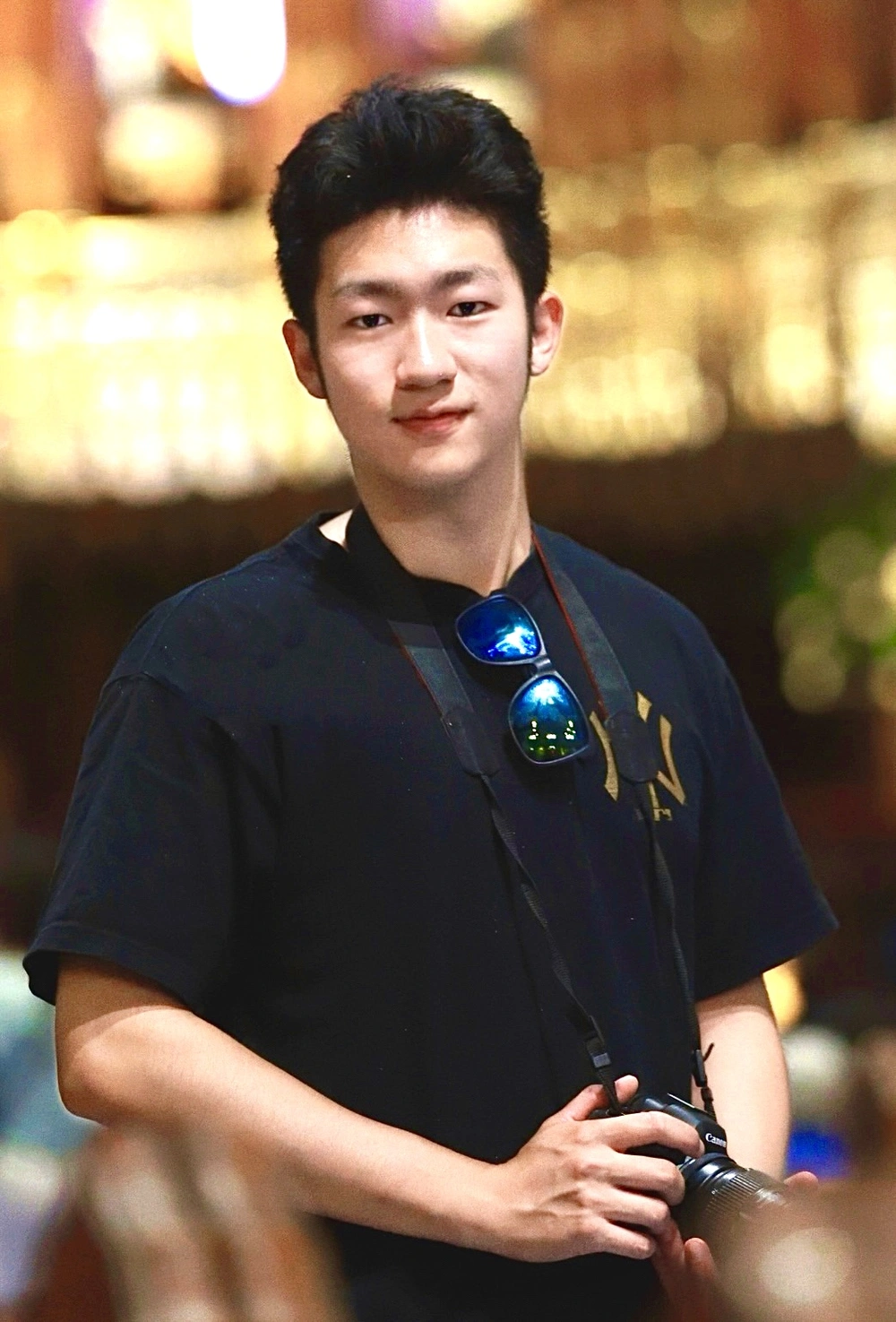 Haolin Yang holding a camera at Basilique Notre-Dame de Montréal
